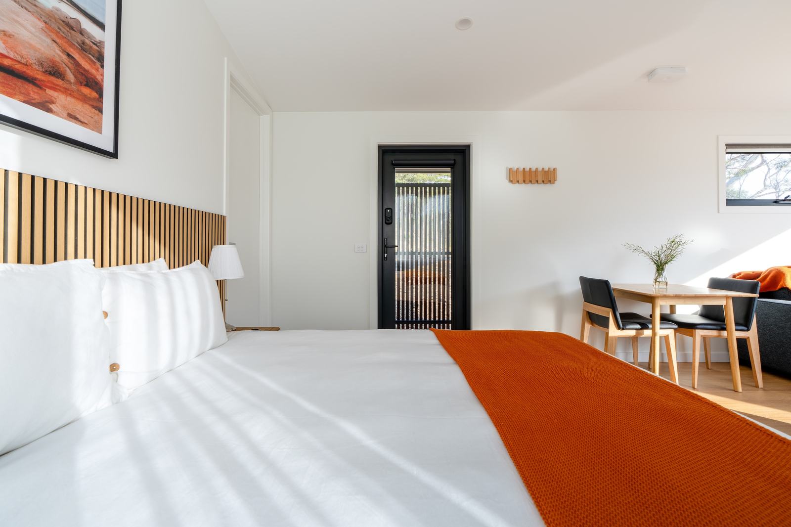 Bedroom of ironbark cabin looking to entry door