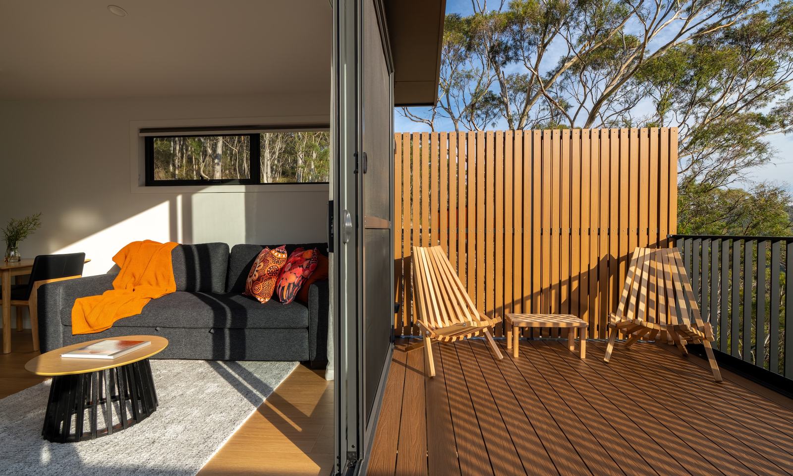 Split screen between living room and deck of ironbark cabin