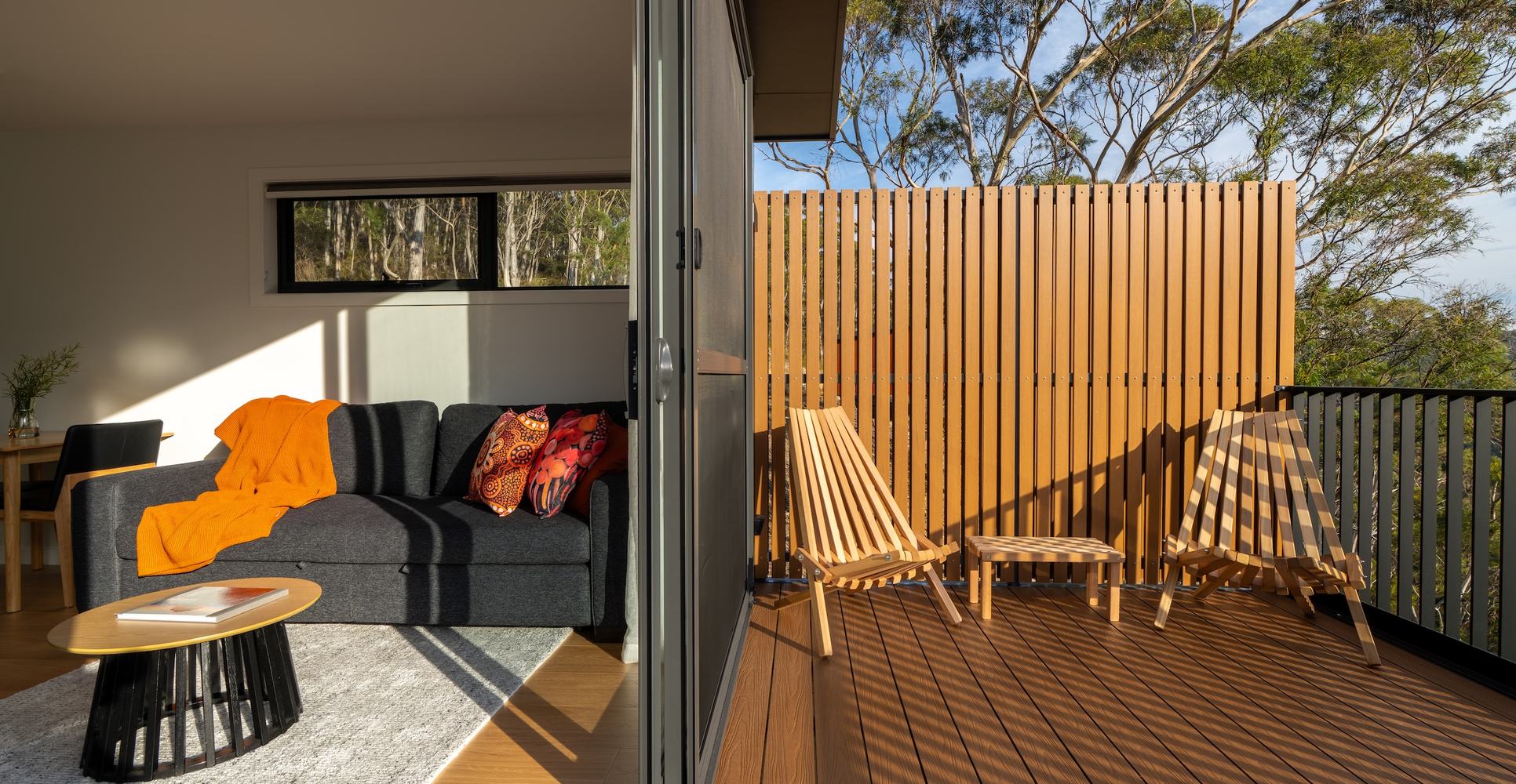 Split screen between living room and deck of ironbark cabin