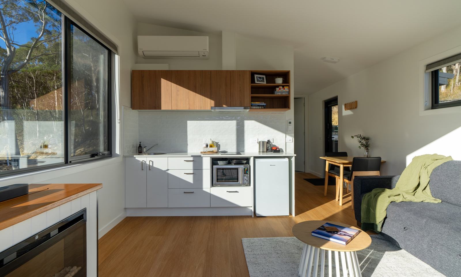 Mosswood kitchen showing electric fireplace and large windows