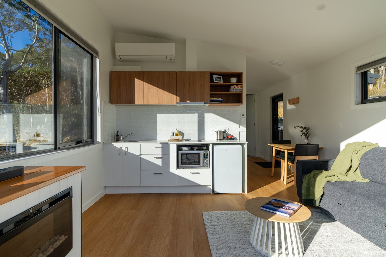 Mosswood kitchen showing electric fireplace and large windows