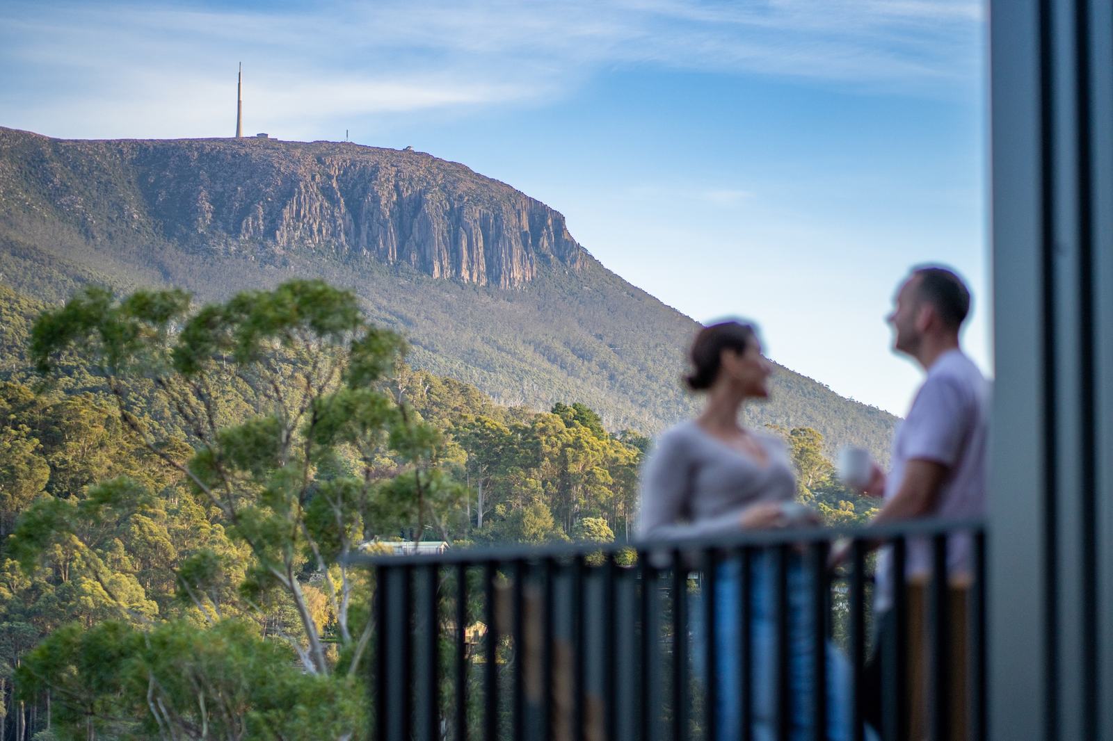 People standing on deck talking, with clear view of kunanyi mt wellington