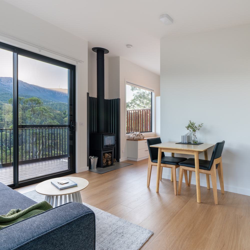 Kitchen and living room layout looking out to the view through large sliding door