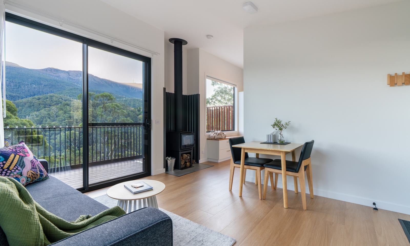 Kitchen and living room layout looking out to the view through large sliding door