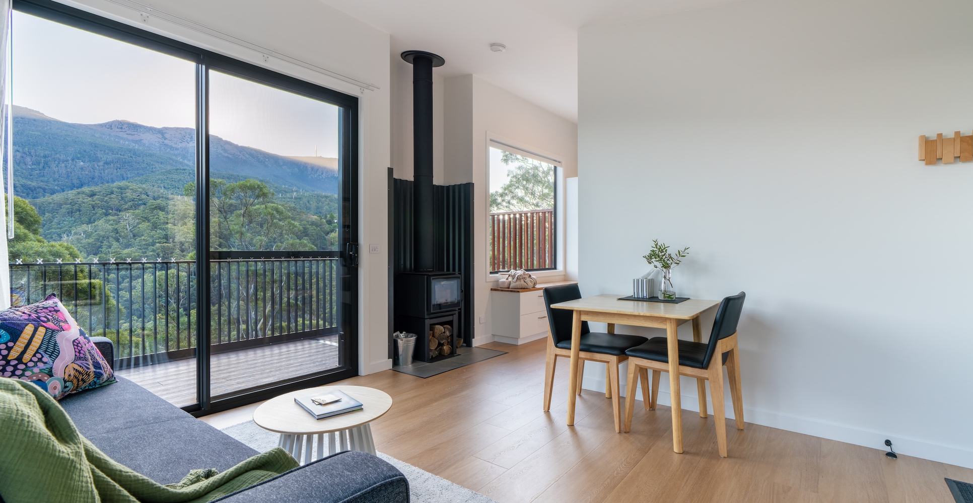Kitchen and living room layout looking out to the view through large sliding door