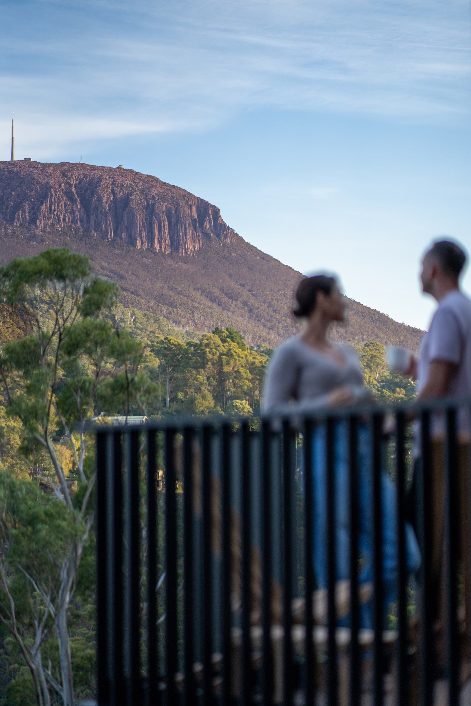People standing on deck talking, with clear view of kunanyi mt wellington