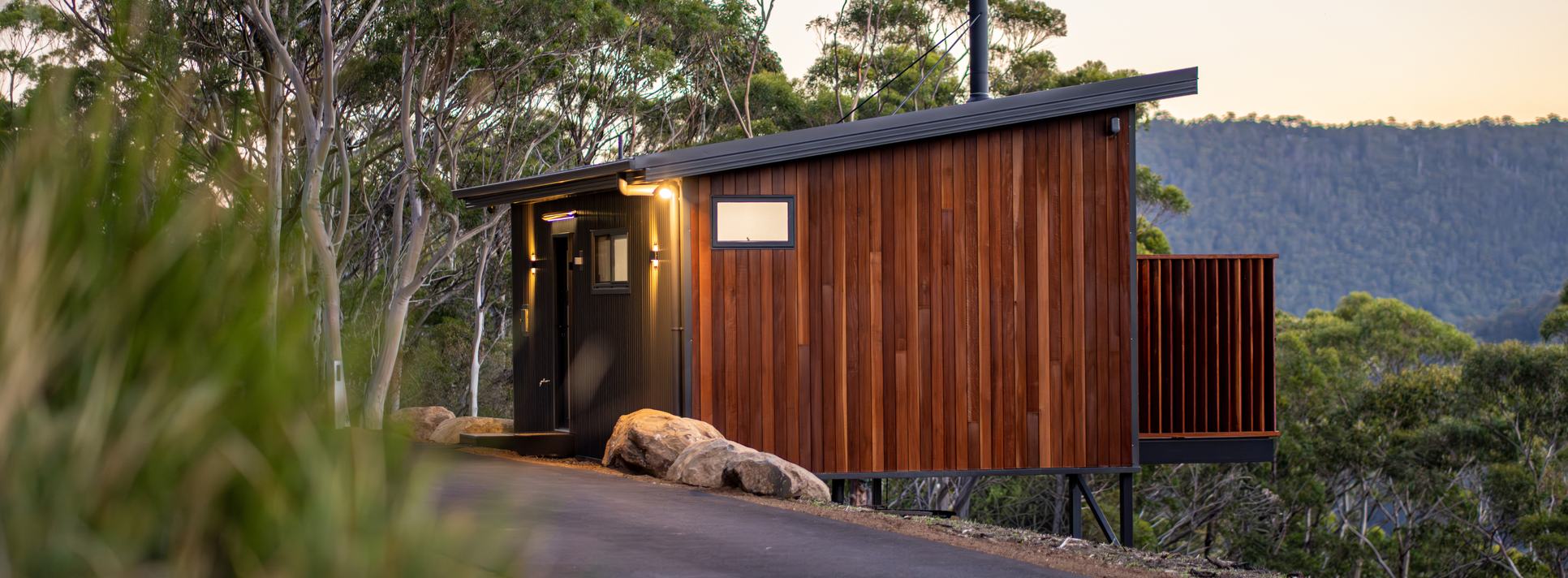 Timber-clad Breath cabin surrounded by native forest in Fern Tree.