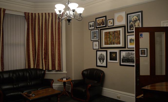 Interior of escape room leather lounge with pictures on the walls