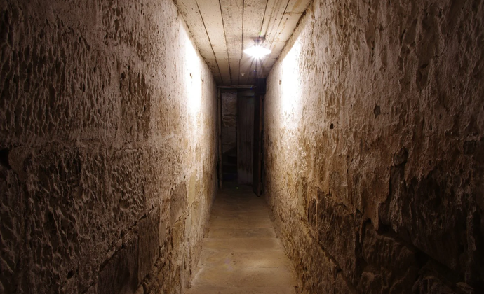 Inside a dark hallway of a convict jail